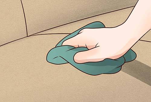 Cleaning the sofa with a soft cloth