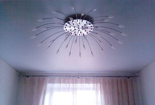 Matte stretch ceiling with chandelier