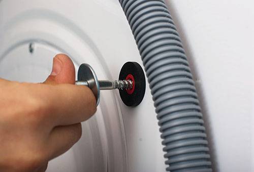 Removing the transport bolt from the washing machine