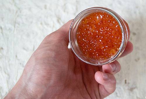 Red caviar in a glass jar