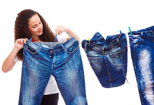 Girl hangs jeans for drying.