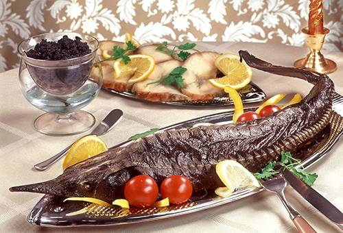 Baked sterlet on the festive table