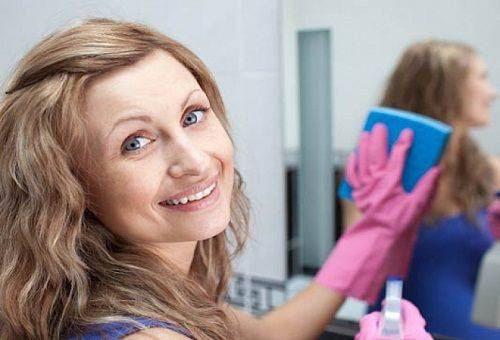 woman washes a mirror