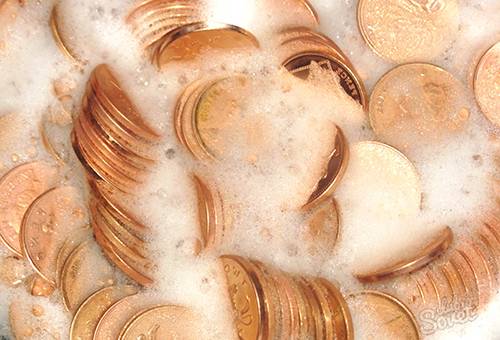 Cleaning coins in soapy water