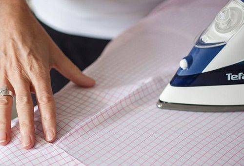 woman ironing a shirt