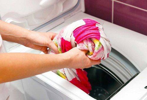 loading laundry into the machine