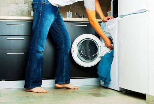 loading laundry into the machine