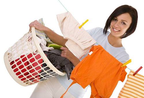 Woman hangs washed clothes