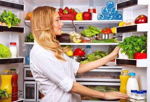 girl at the open fridge