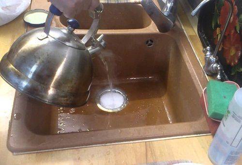 draining boiling water into the sink