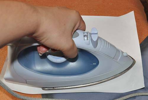 Removing stains of diesel fuel with an iron