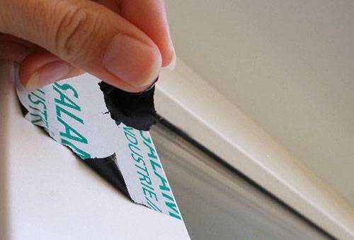 Removing a film from a plastic window frame