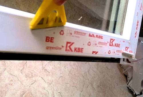 Removing window film with a scraper