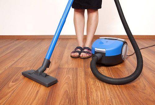 girl is vacuuming the floor