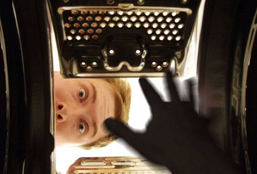A man looks into a washing machine