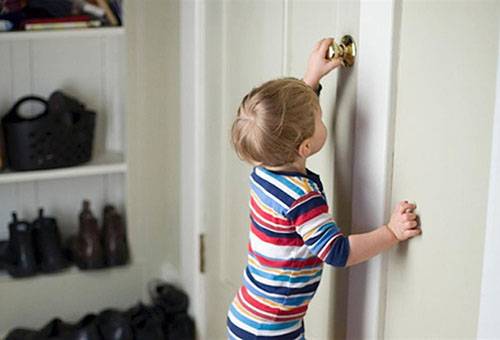 Child is trying to open the door