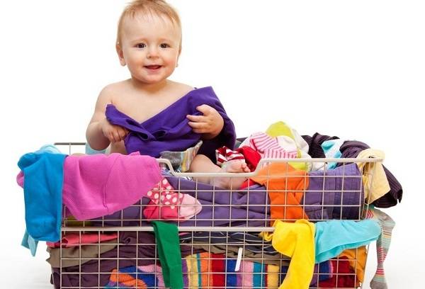 baby and baby clothes in a basket