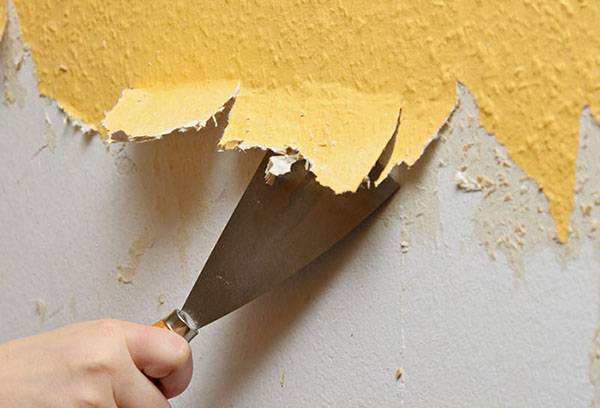Removing old wallpaper with a spatula