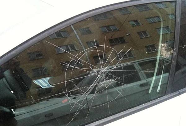 Deep scratches on the side window of a car