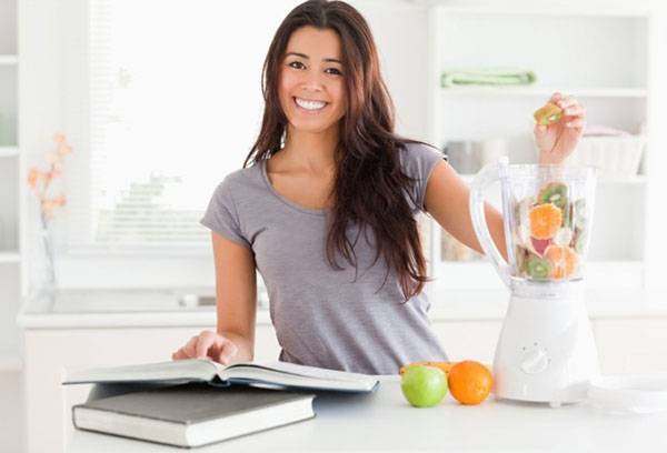 Girl uses a stationary blender