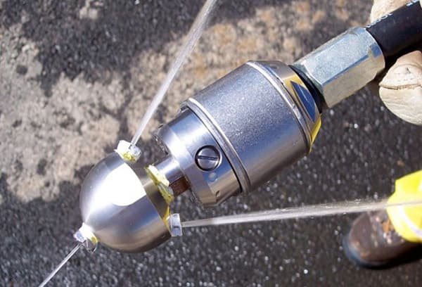 Nozzle for hydrodynamic pipe cleaning