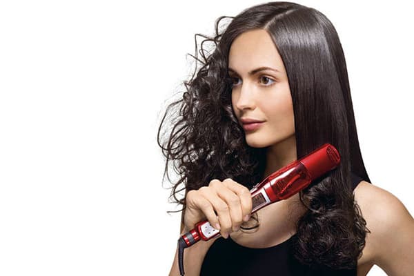Girl straightens her hair
