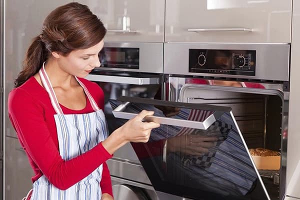 Girl cooks a pie in the oven