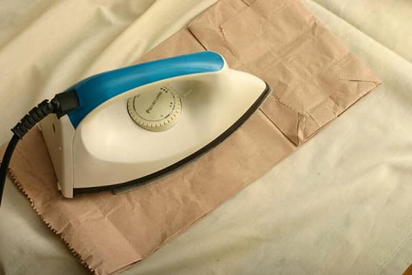 Ironing fabric through paper