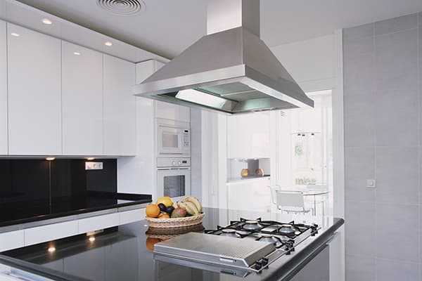 Large ceiling hood over the kitchen island