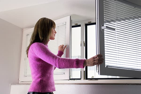 Girl opens a window for airing