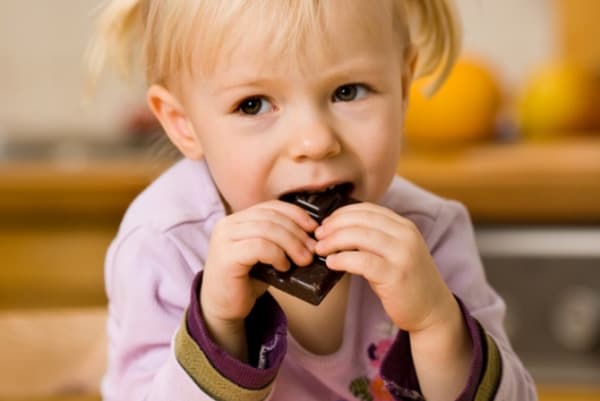Little girl eating hematogen