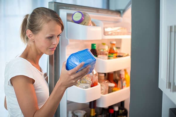 The girl conducts an audit in the refrigerator
