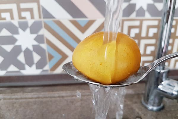 Painted egg under running water