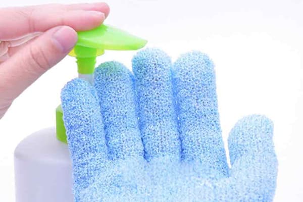 Putting soap on a washing glove