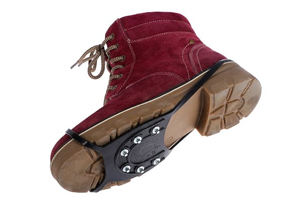 Ice shoe on the sole of a winter boot