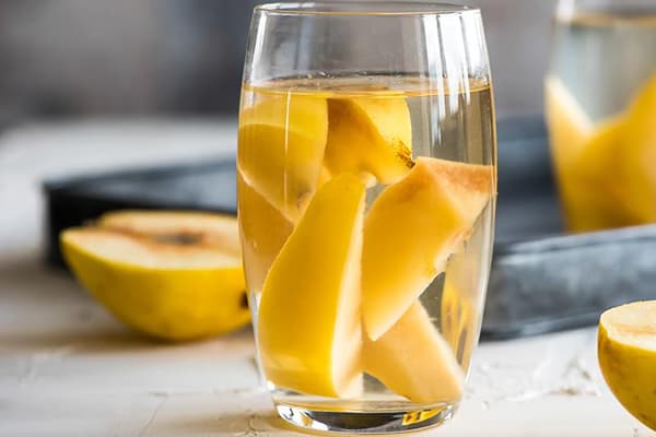 Quince slices in a glass with water
