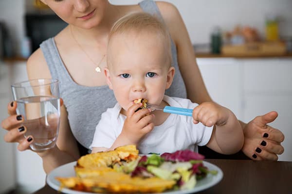 Feeding a baby from his plate