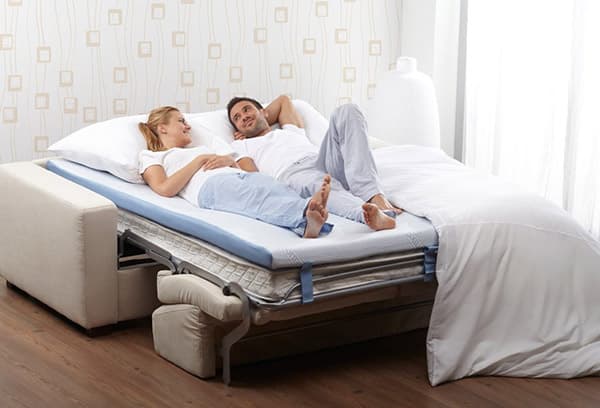 A pair lies on a correcting mattress pad