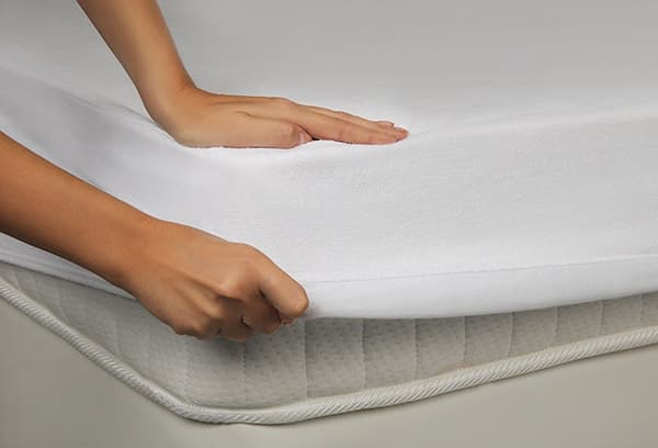 Girl puts on a mattress pad