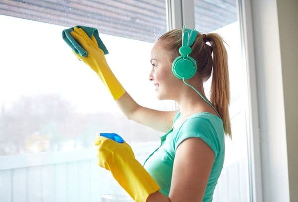 Girl in headphones cleaning