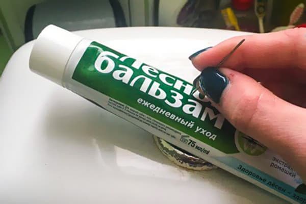 Piercing a tube of toothpaste