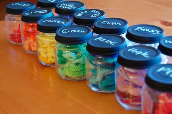Colored rubber bands in jars of baby food