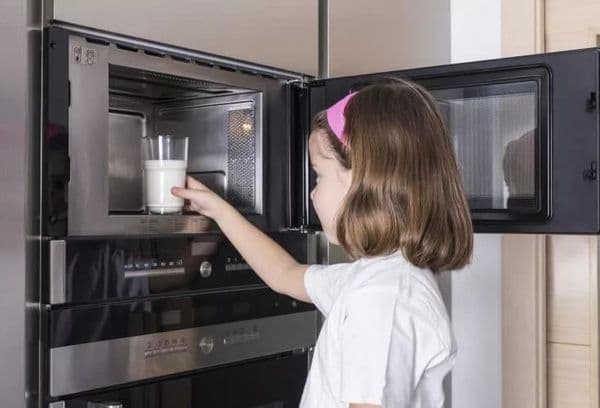 Girl warms milk