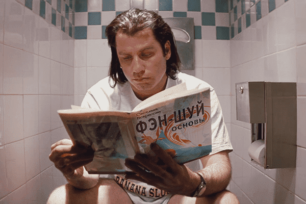 John Travolta reads a book on Feng Shui