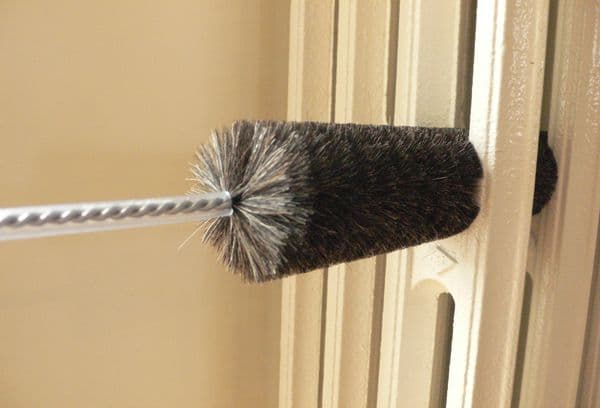 cleaning the radiator with a brush