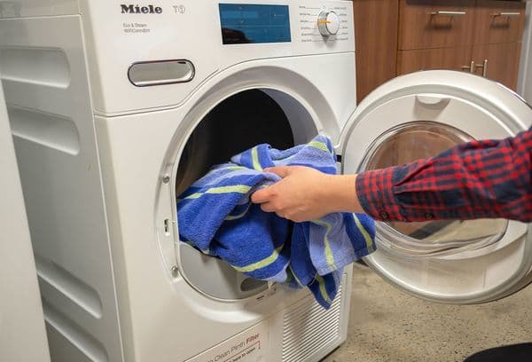 loading laundry into the machine