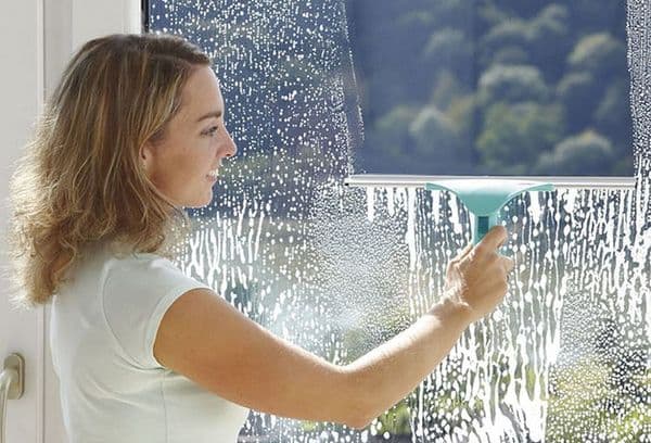 Girl washes a window