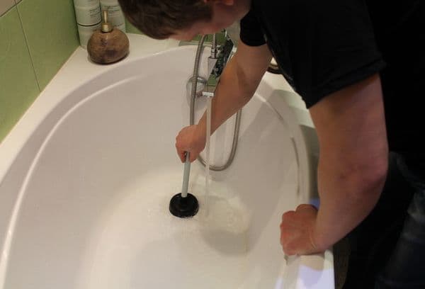 plunger cleaning the bathroom drain