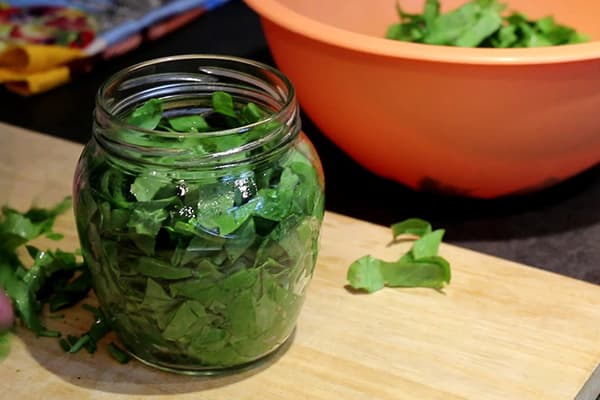 Chopped sorrel in a glass jar