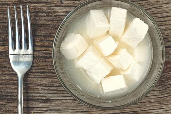 Pieces of feta cheese in brine